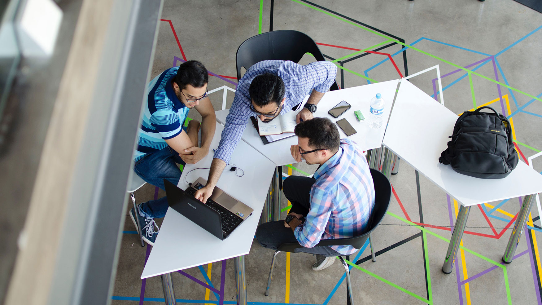 Three businessmen working at a table
