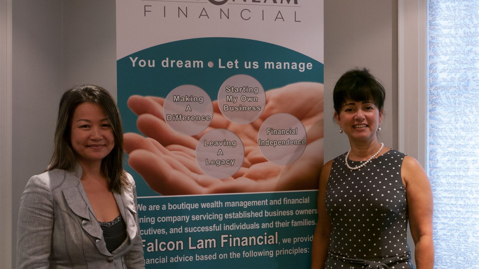Image of falcon lam employees standing by a banner