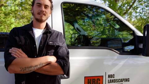 photo of Ziggy standing next to his pickup work truck