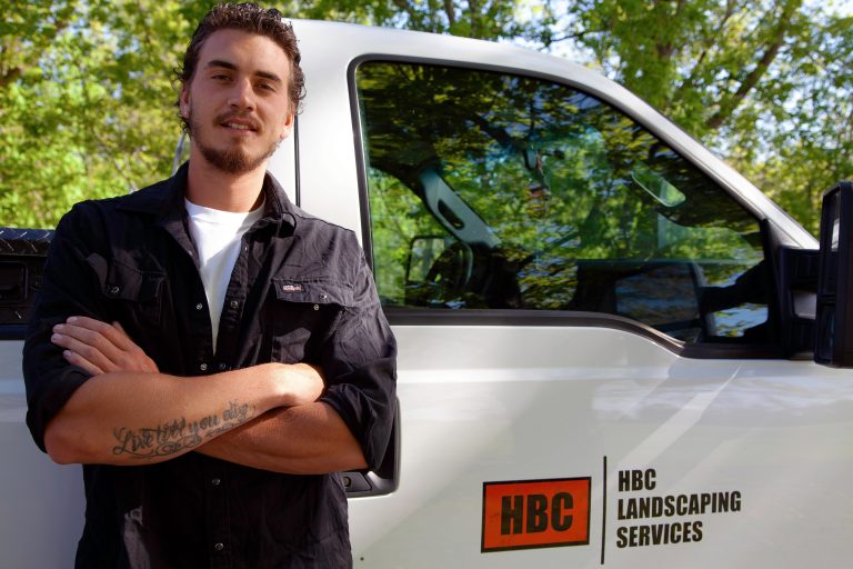 photo of Ziggy standing next to his pickup work truck
