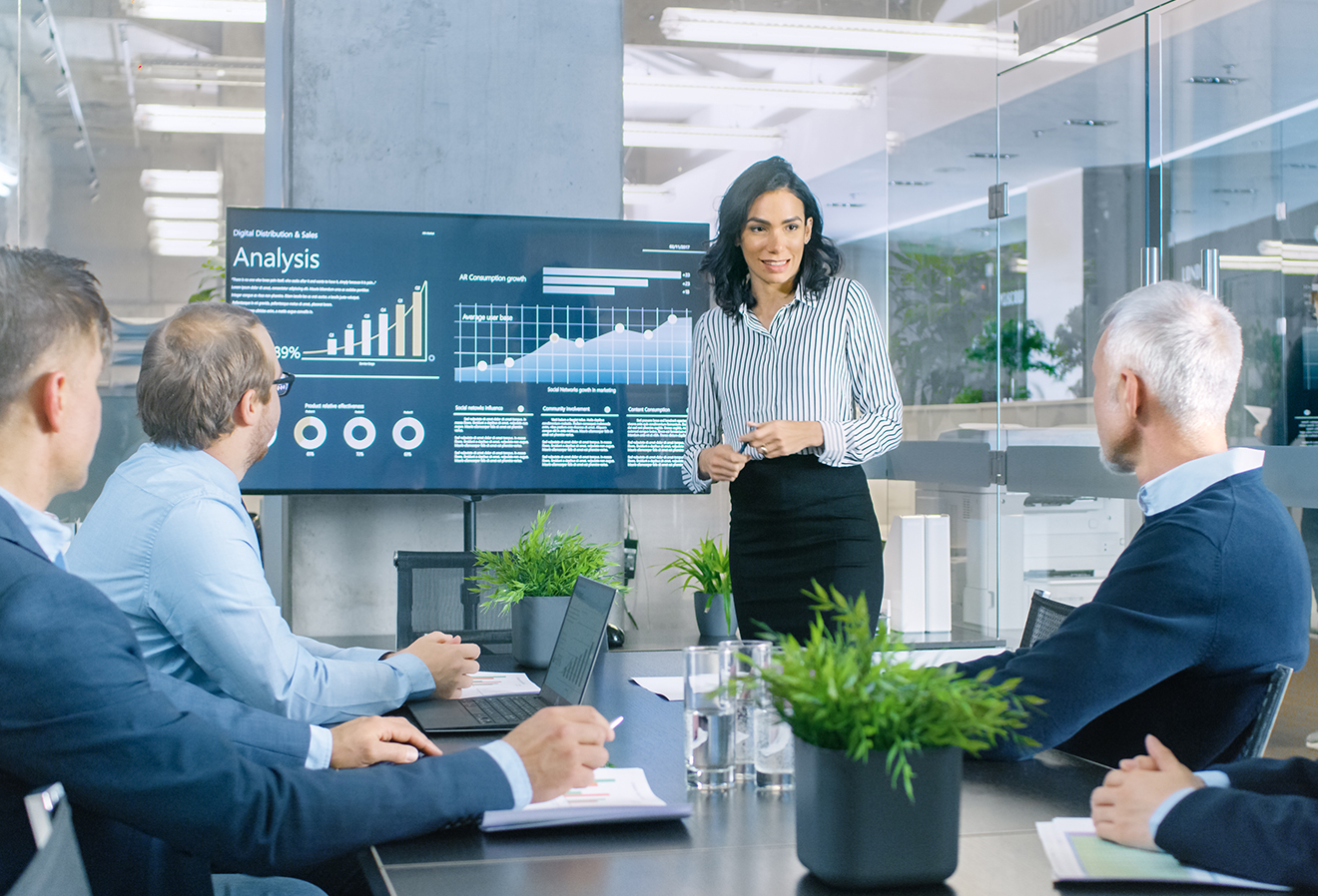Lady presenting in a boardroom
