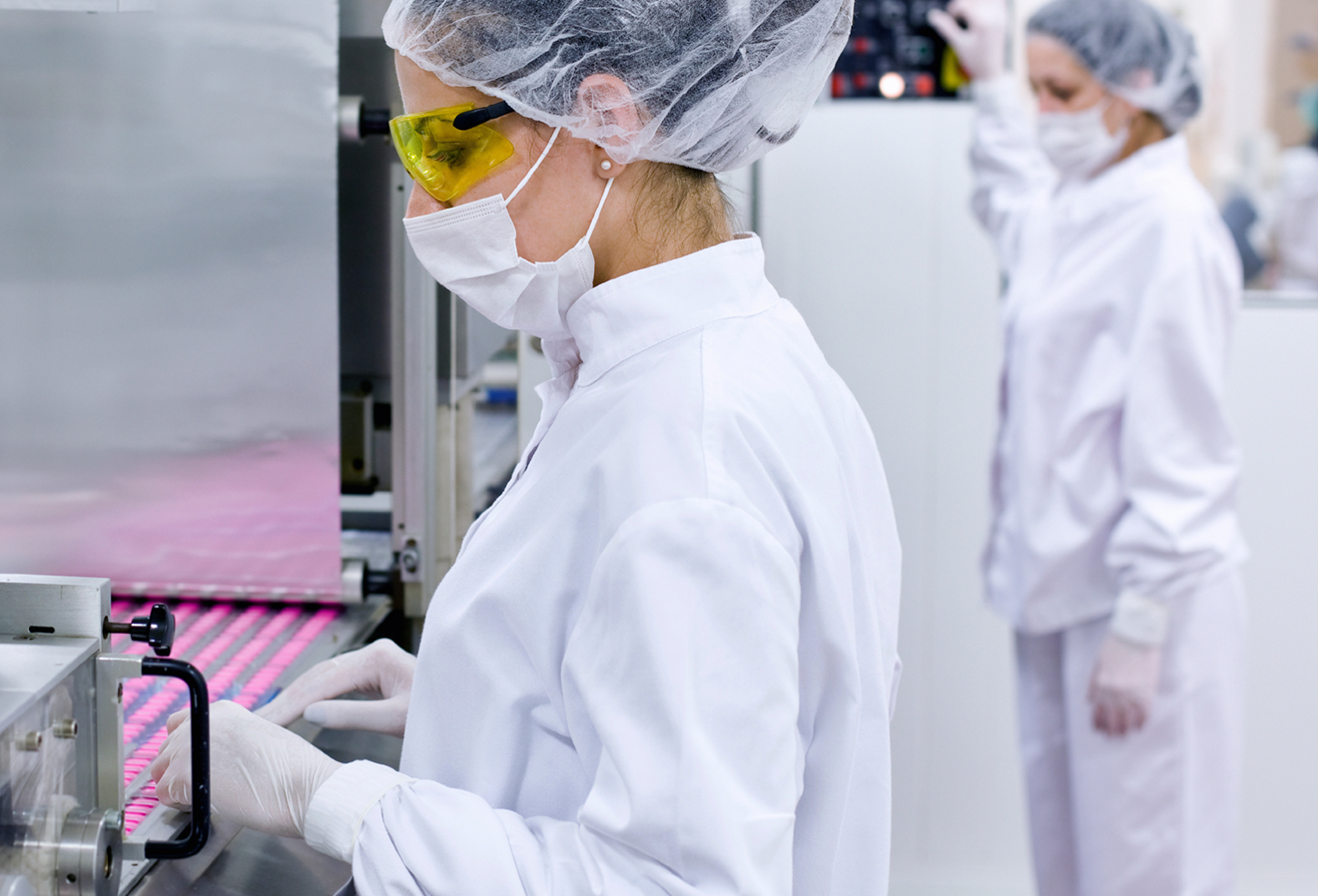 Woman working on pharma production line