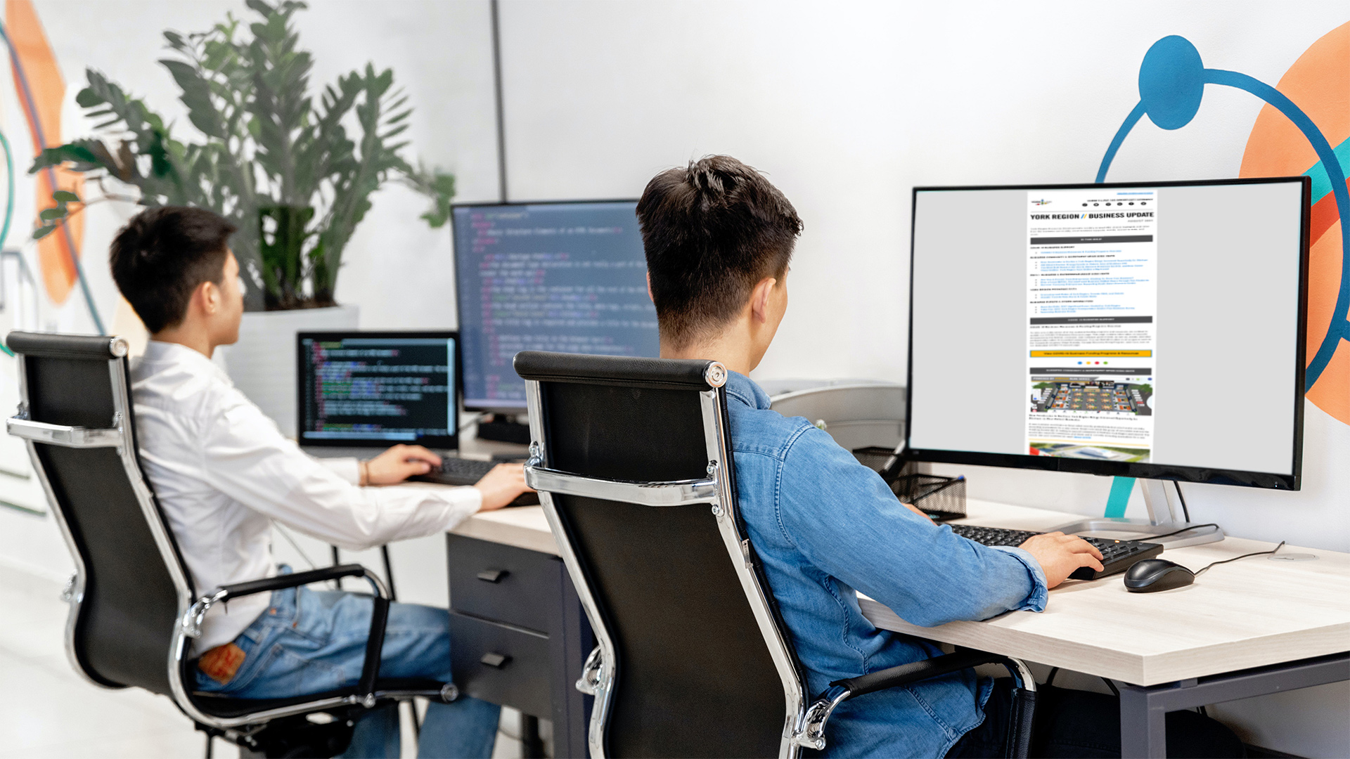 Two professionals working on computers