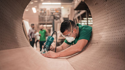 Man Using A Tool in Manufacturing Facility