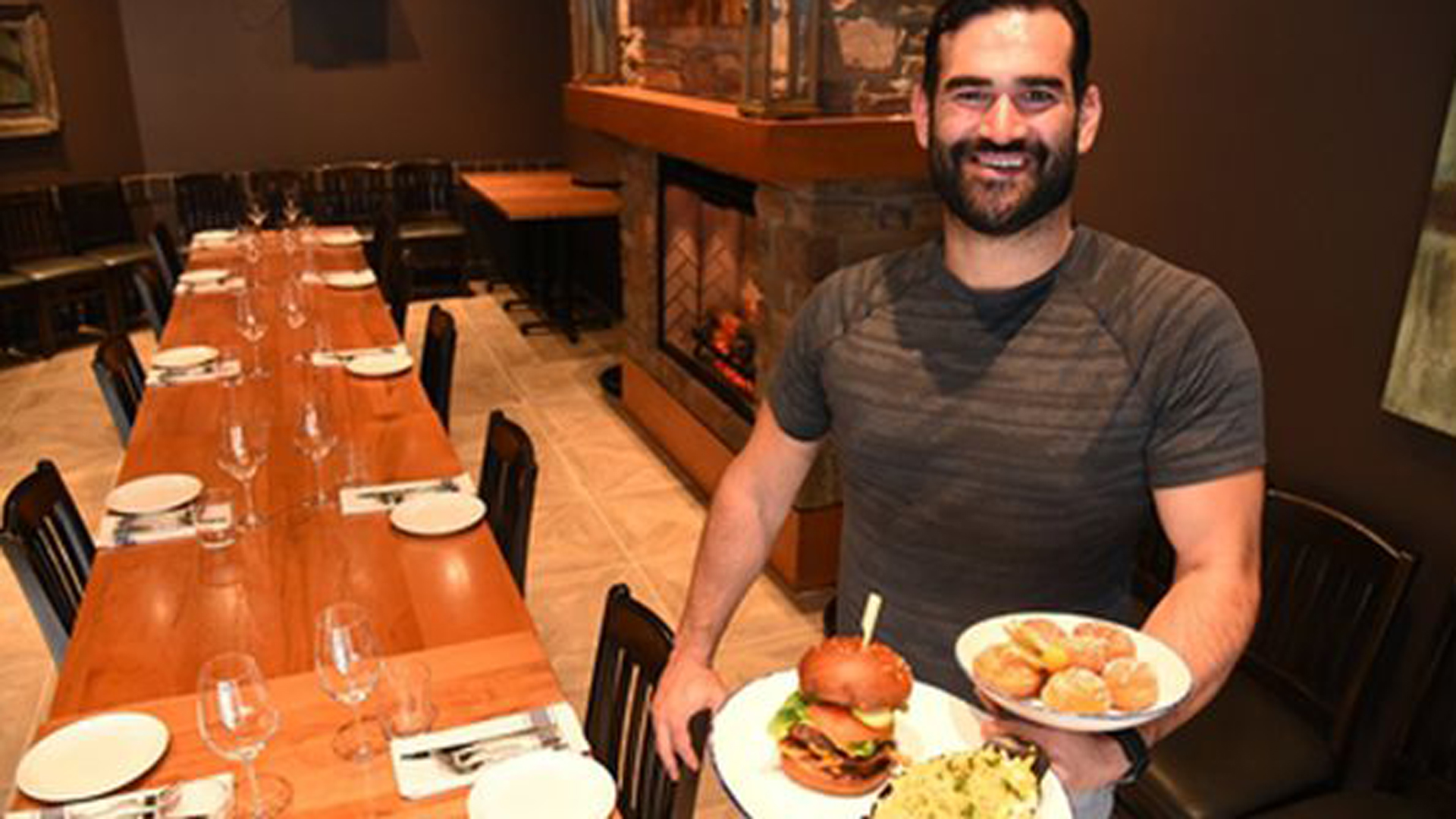 Smash Bar owner showing a plate of food