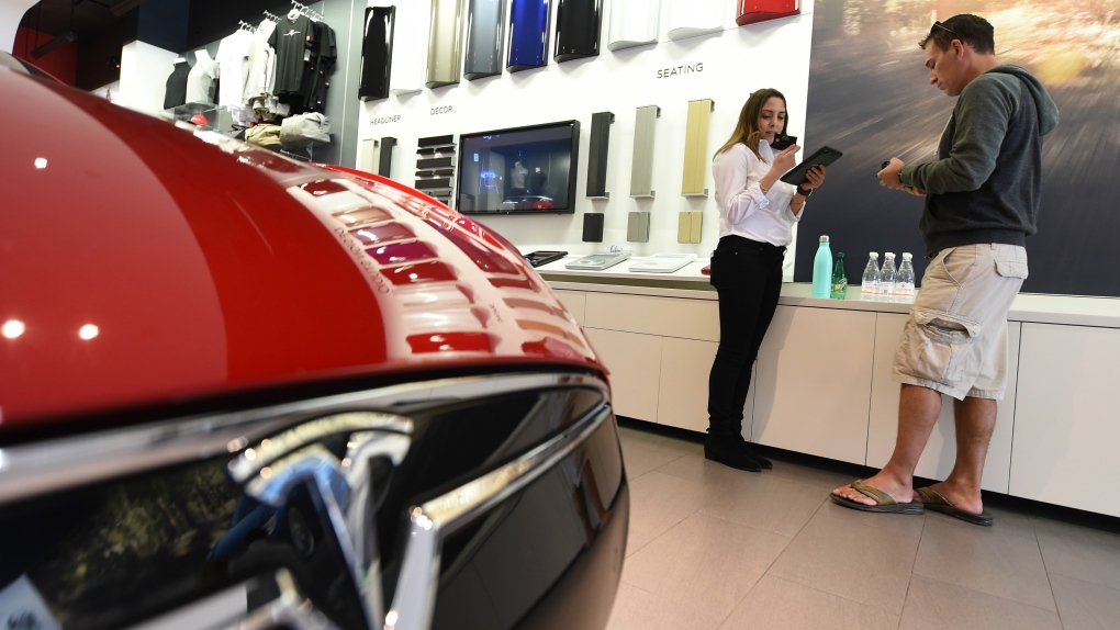 front end of a red Tesla in a show room