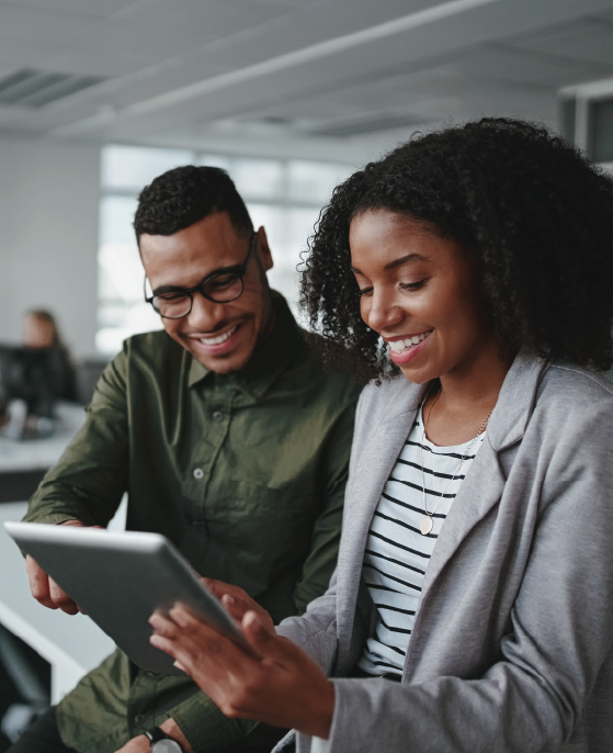 resource-pic A young woman and man are viewing business resources on a mobile tablet together