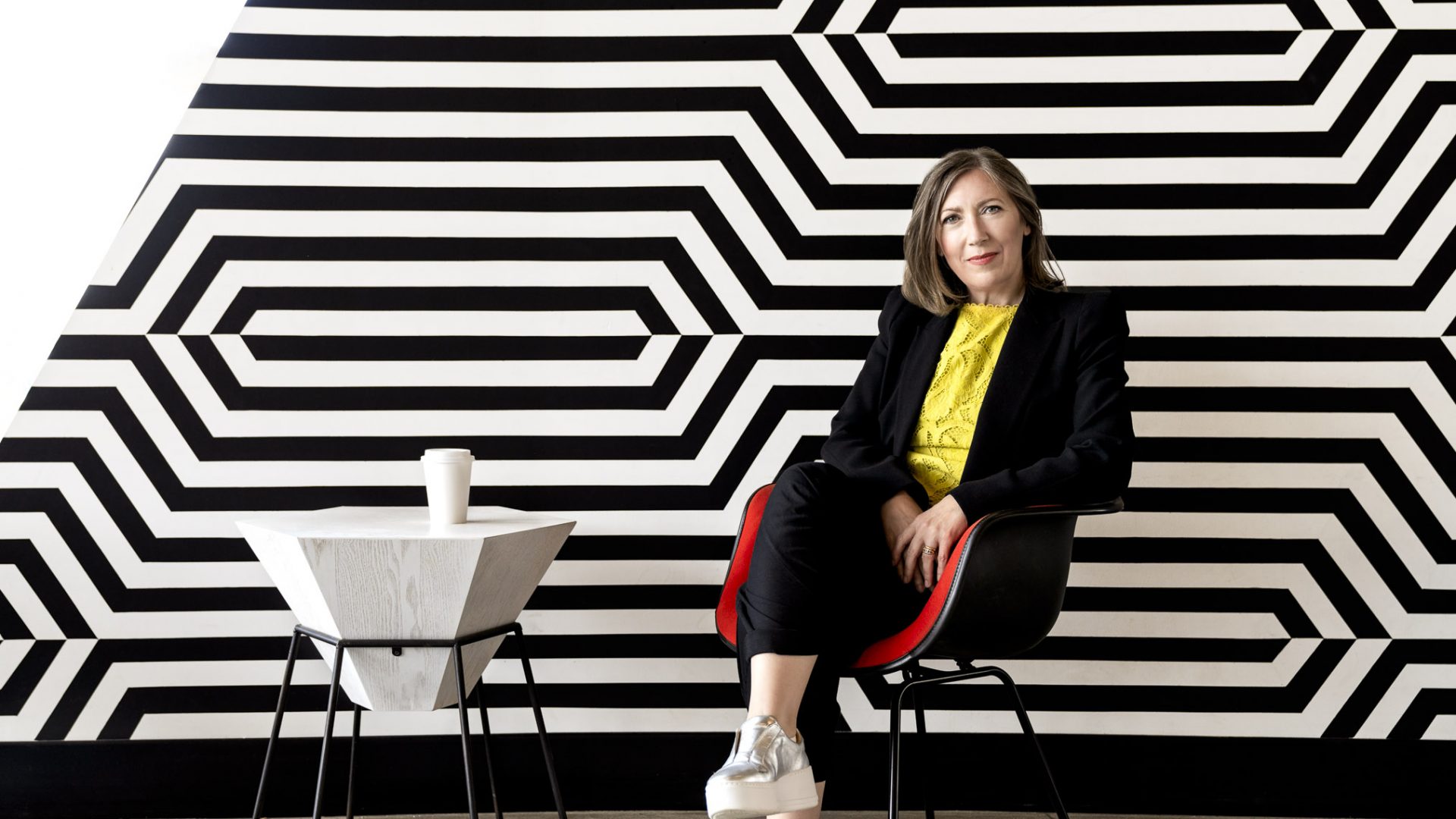 Dean Jane Goodyer sitting on a chair in York University