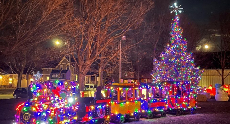 Christmas market at night with kids train lit up with Christmas lights in the Aurora town park