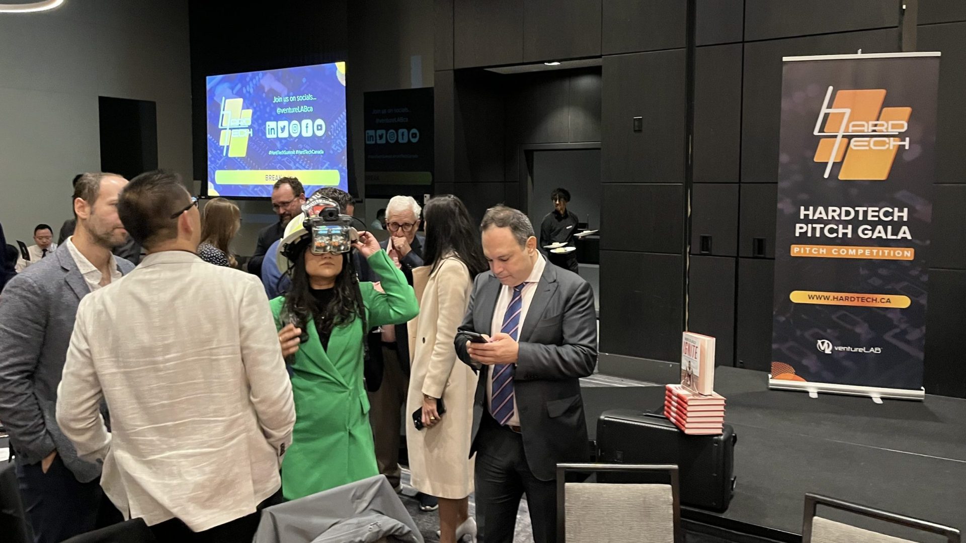 Woman in green testing a VR head set at VentureLab's Hard Tech Summit 2023
