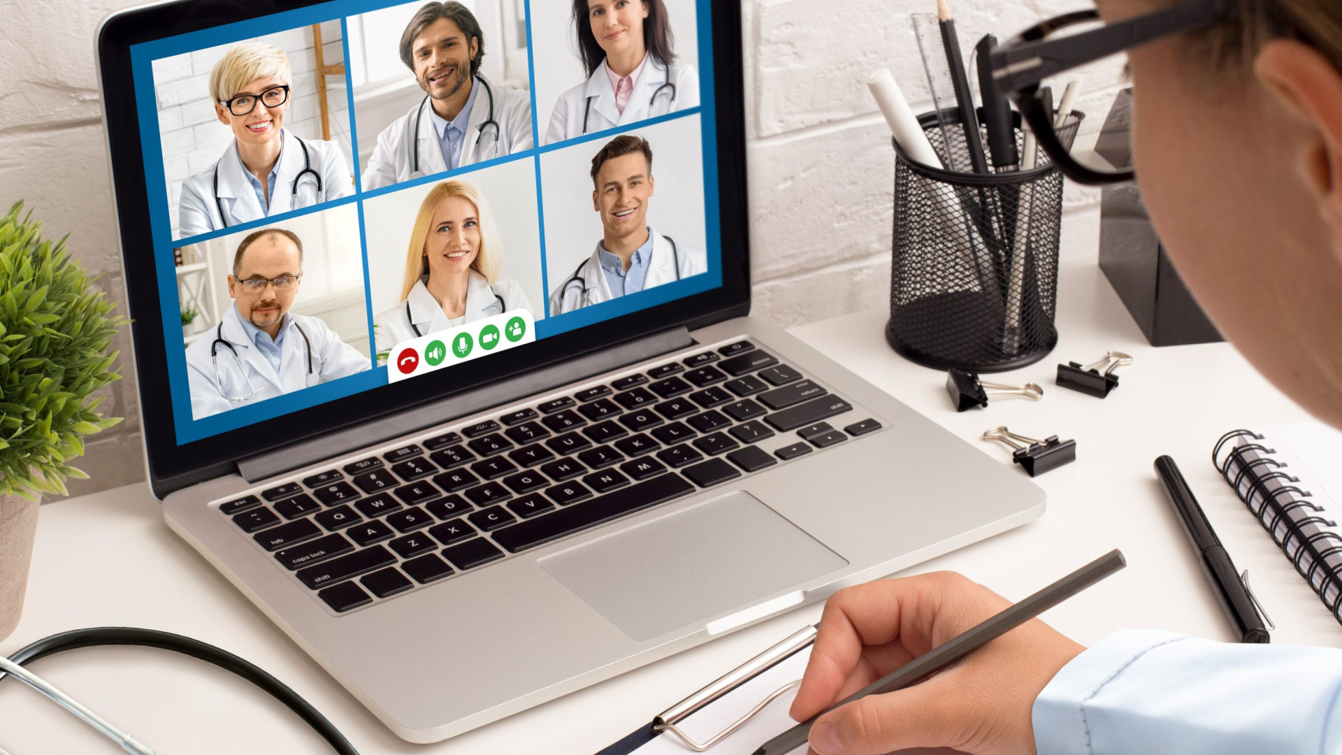 Female Doctor Having Meeting With Colleagues Via Video Call