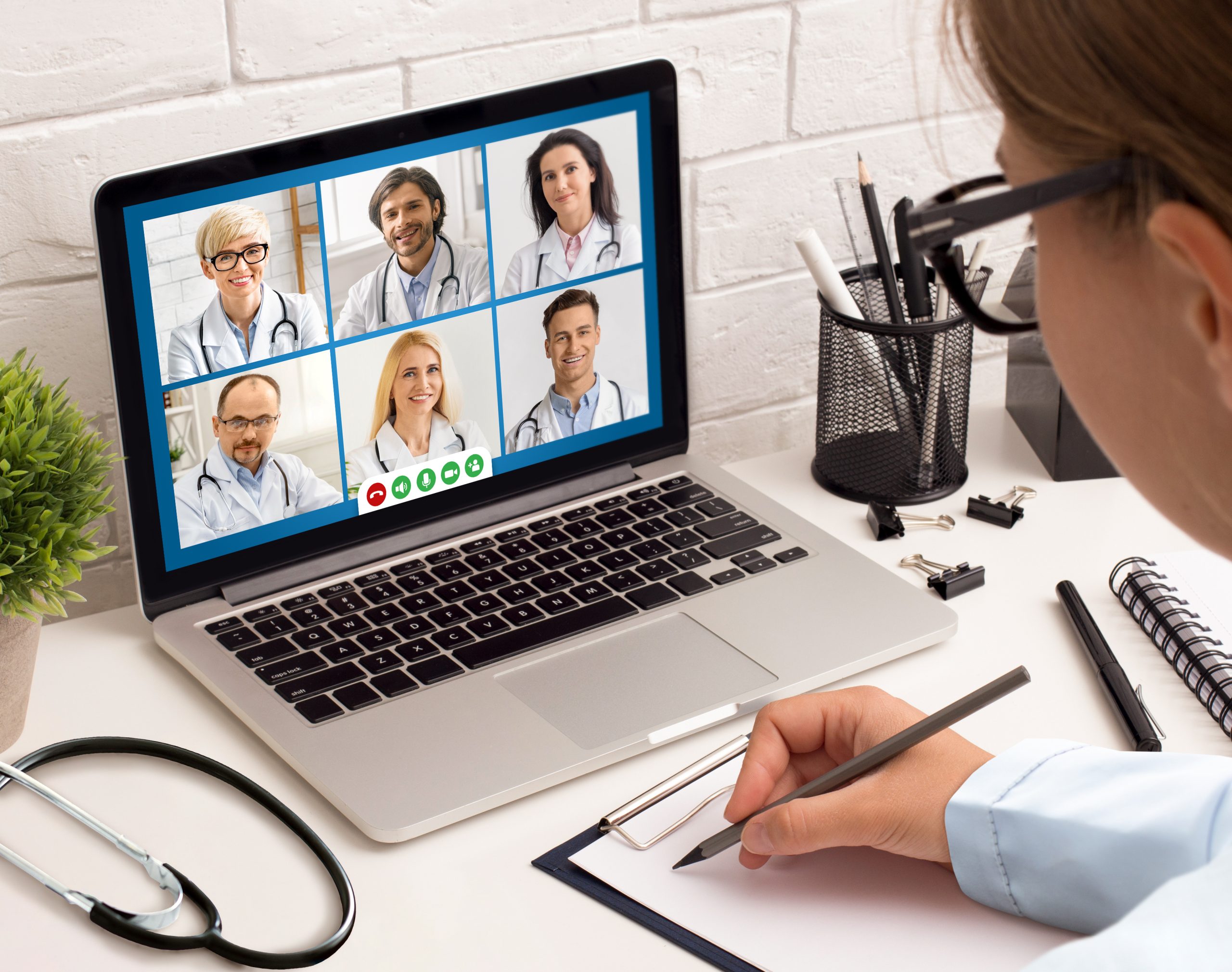 Female Doctor Having Meeting With Colleagues Via Video Call