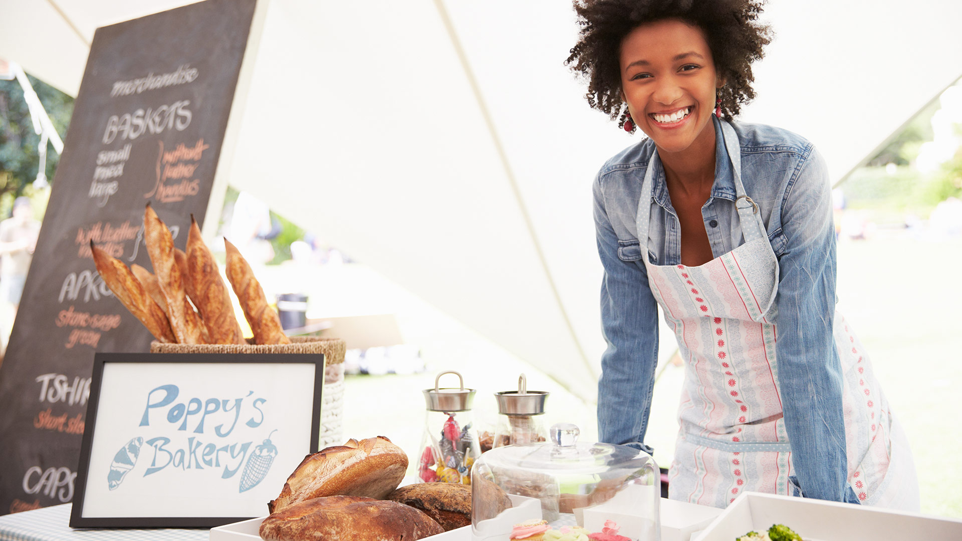 Black entrepreneur selling her products at a marketplace event